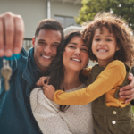 Happy family holding keys to their first home, smiling with excitement and anticipation for the future.